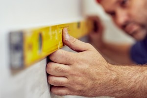 Concrete slab repair expert checks slab leveling